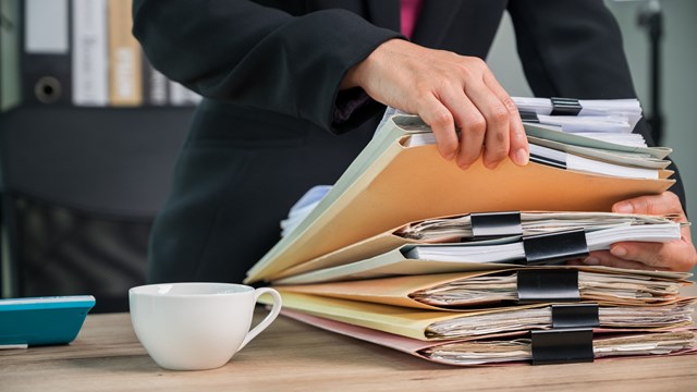 Close up Office employee working with documents at business desk in a business office